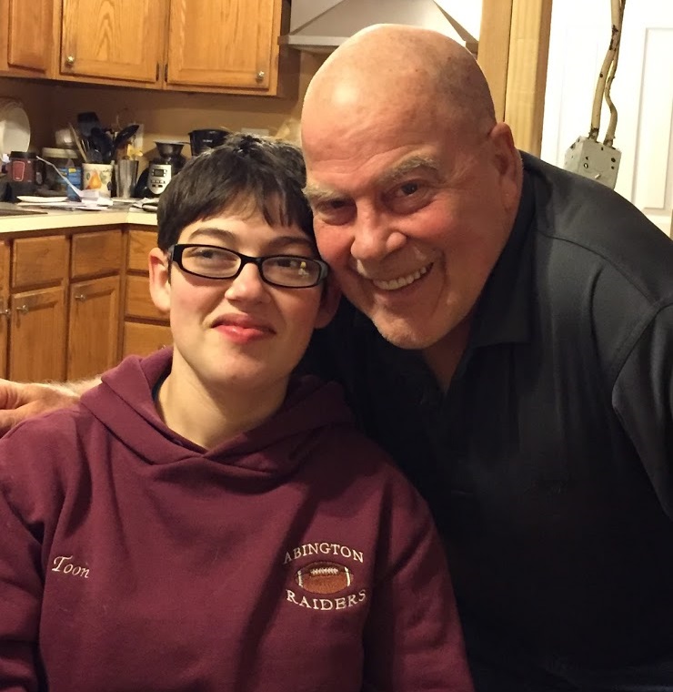 Phil and Lesley pose together, smiling in their kitchen